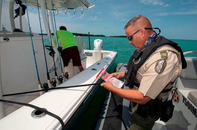 Dipre checks boaters' onboard safety equipment as part of a day's tasks on the water. 