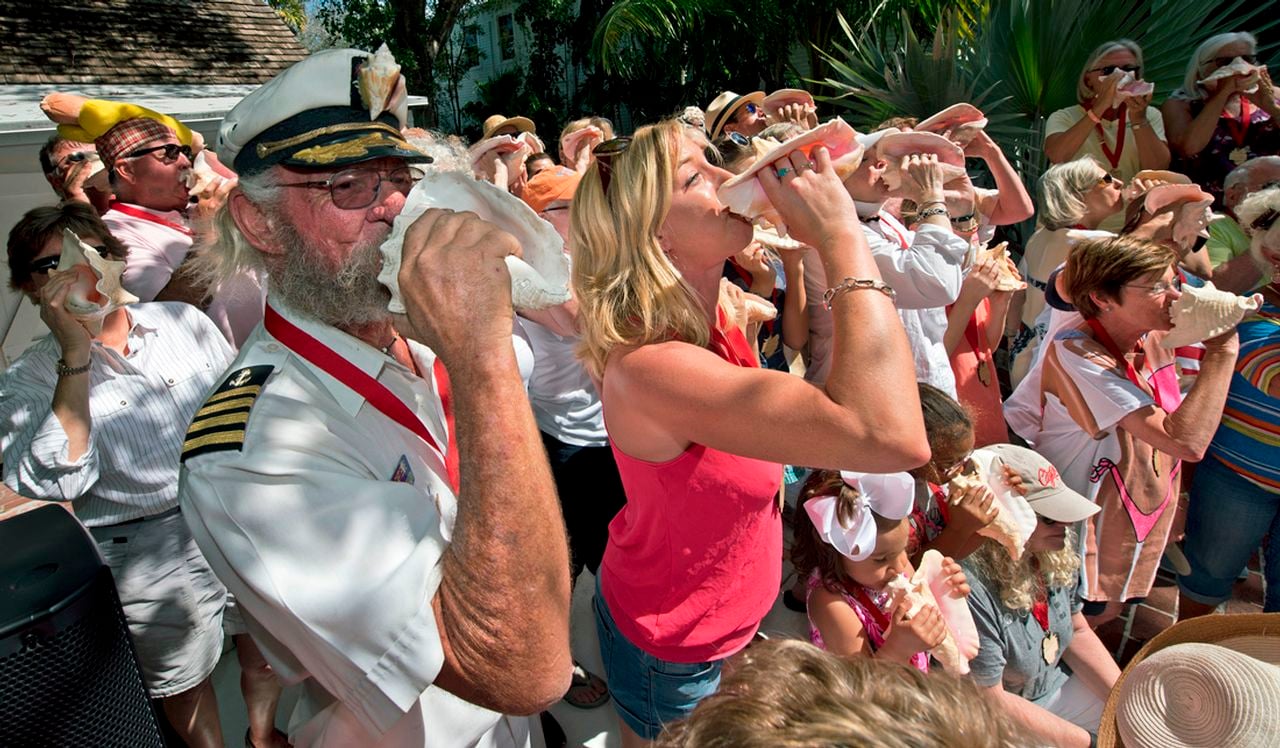 Participants in the annual Conch Shell Blowing Contest display their mollusk musicianship. Photo: Rob O'Neal 